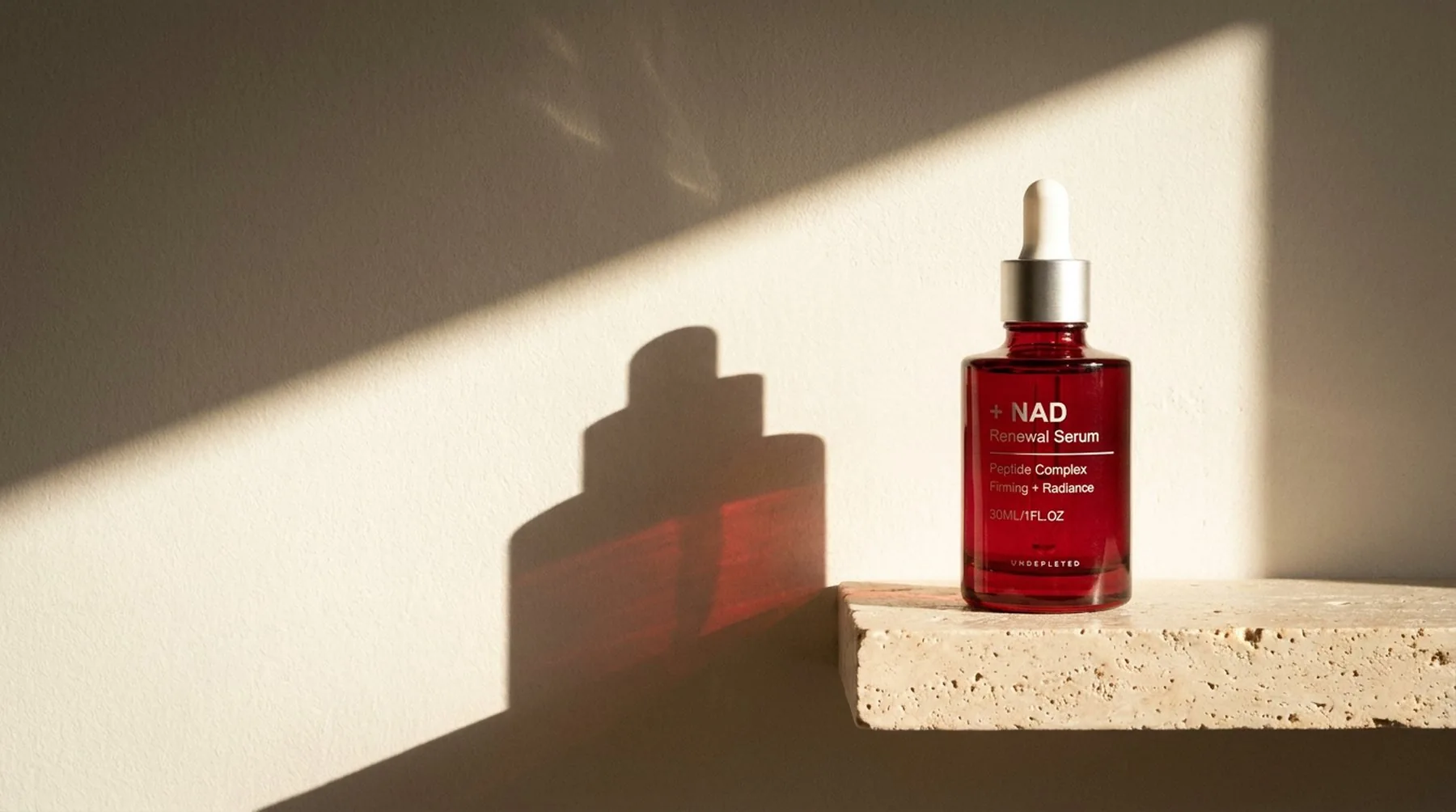 The UNDEPLETED serum bottle and carton on a pale ledge in daylight.